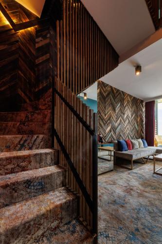 a lobby with stairs and a couch in the background at Mtserlebi Resort in K'vishkhet'i
