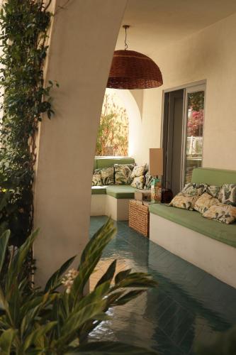 a living room with a pool in the floor at Hotel Terme Oriente - Beach & SPA in Ischia