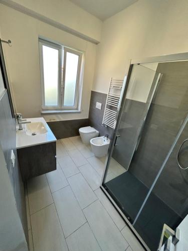a bathroom with a toilet and a sink and a shower at Camera Matrimoniale in Casa Malpensa 501 in Samarate