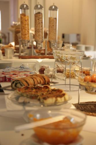 a table with plates of food on a table at Hotel Terme Oriente - Beach & SPA in Ischia