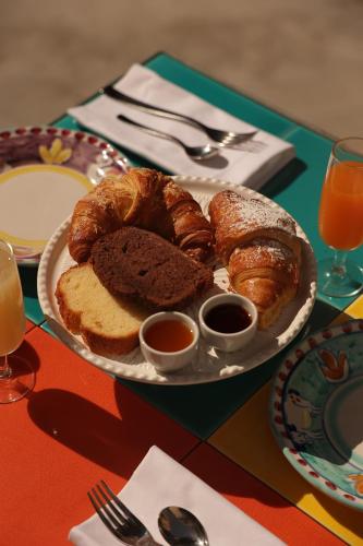 a plate of pastries and bread on a table at Hotel Terme Oriente - Beach & SPA in Ischia
