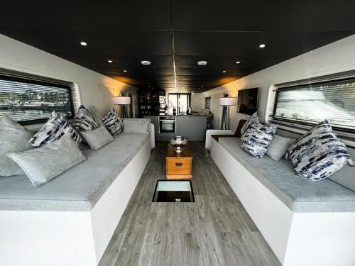 a living room with a couch in a rv at Island Harbour Houseboat in Newport