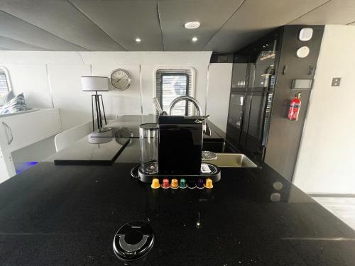 a kitchen with a table with a blender on it at Island Harbour Houseboat in Newport