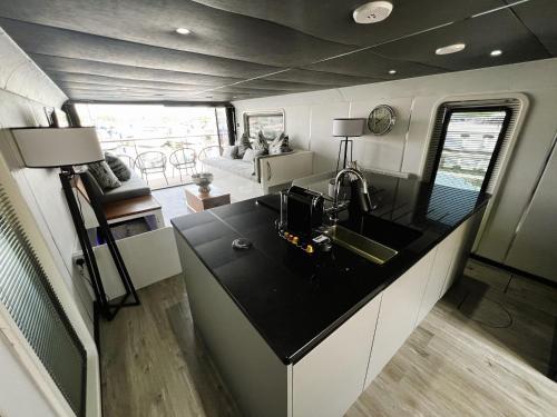 an aerial view of a kitchen and living room in an rv at Island Harbour Houseboat in Newport