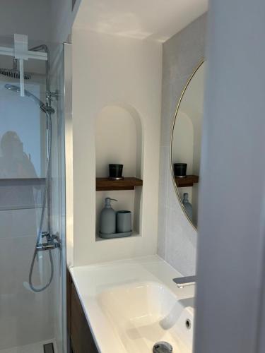 a bathroom with a sink and a mirror at Apartments Ivas in Zambratija