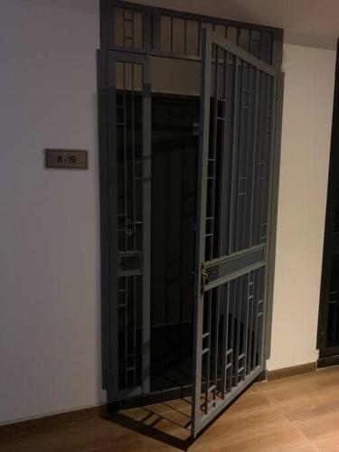 a glass door in a room with a wall at Noah's Studio in Shah Alam
