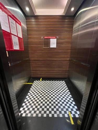 a room with a checkered floor in a elevator at Noah's Studio in Shah Alam