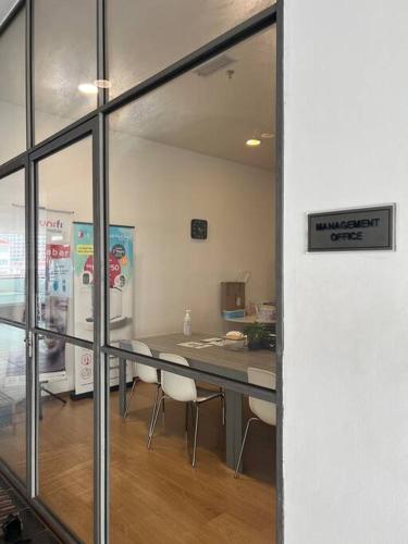 a room with a table and chairs in a kitchen at Noah's Studio in Shah Alam