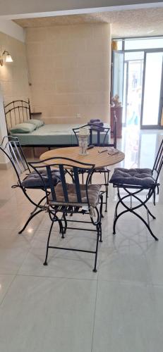 a table and two chairs and a table and chairs at Studio Flat near Sea in Xlendi