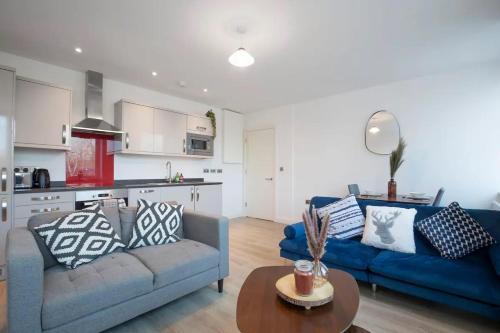 a living room with a blue couch and a table at Central Gloucester Getaway Retreat W/Free Parking 