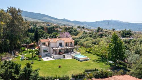 an aerial view of a house with a yard at Horizon Villa-Private Pool-7 Bedroom-Gym-Sea View in Psalidi