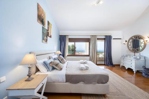 a bedroom with a bed and a table and a window at Horizon Villa-Private Pool-7 Bedroom-Gym-Sea View in Psalidi