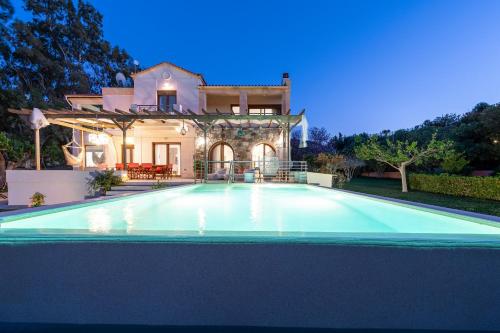 a villa with a swimming pool in front of a house at Horizon Villa-Private Pool-7 Bedroom-Gym-Sea View in Psalidi