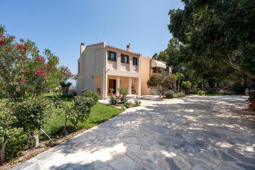 a stone driveway leading to a large house at Horizon Villa-Private Pool-7 Bedroom-Gym-Sea View in Psalidi