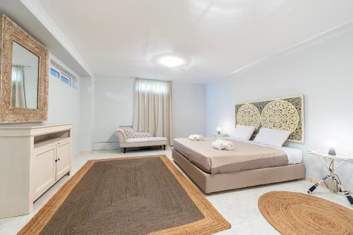 a bedroom with a large bed and a mirror at Horizon Villa-Private Pool-7 Bedroom-Gym-Sea View in Psalidi