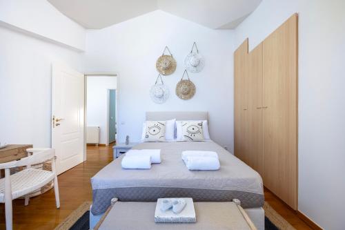 a bedroom with a bed with two towels on it at Horizon Villa-Private Pool-7 Bedroom-Gym-Sea View in Psalidi