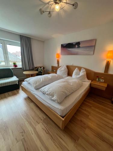 a bedroom with a large bed and a living room at Rohrbacher Herz in Rohrbach in Oberösterreich