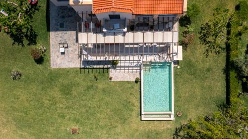 an overhead view of a house with a swimming pool at Horizon Villa-Private Pool-7 Bedroom-Gym-Sea View in Psalidi