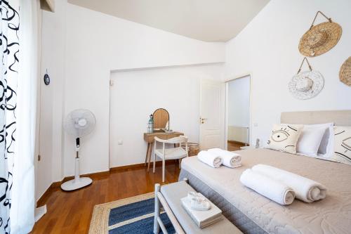 a white bedroom with a bed and a desk at Horizon Villa-Private Pool-7 Bedroom-Gym-Sea View in Psalidi
