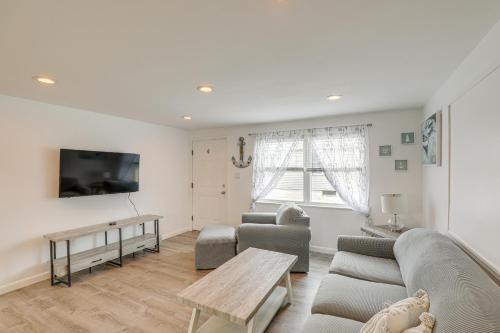 a living room with a couch and a table at Beachfront Salisbury Retreat with Fire Pit and Grill in Salisbury