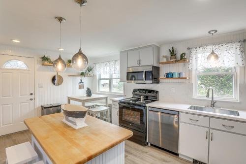 a kitchen with a sink and a stove top oven at Beachfront Salisbury Retreat with Fire Pit and Grill in Salisbury
