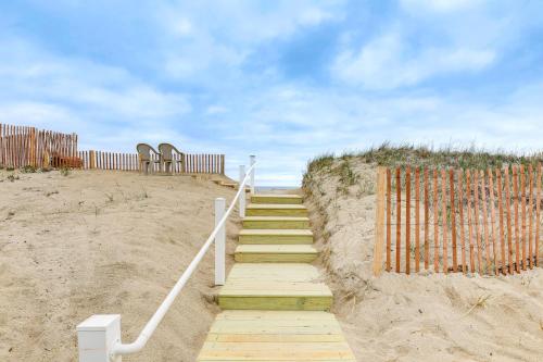 a stairway leading up to a beach with a fence at Beachfront Salisbury Retreat with Fire Pit and Grill in Salisbury