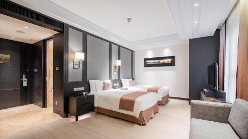 a hotel room with two beds and a television at Crowne Plaza Shanghai Anting-Auto City - 15 Minutes drive to F1 in Jiading