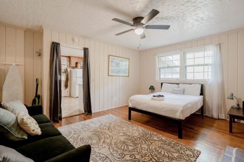 a bedroom with a bed and a ceiling fan at 5 mins to Fort Jackson - The Wooded Hilltop Ranch in Columbia