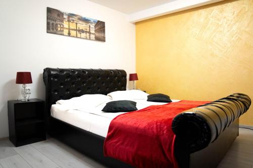 a bedroom with a bed with a red blanket at Casa Alis in Oradea