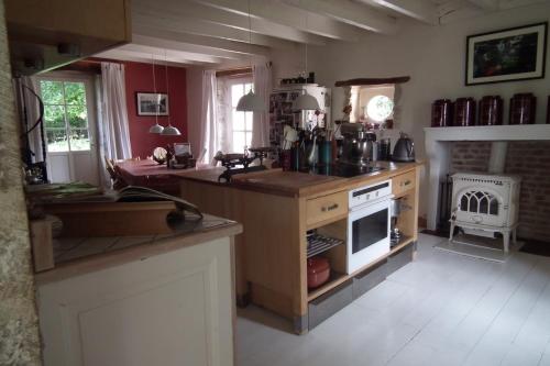 a kitchen with a counter and a stove top oven at B&B Au Pain Quotidien in Barizey