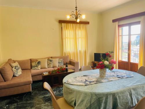 a living room with a table and a couch at ELIA in Doukádes