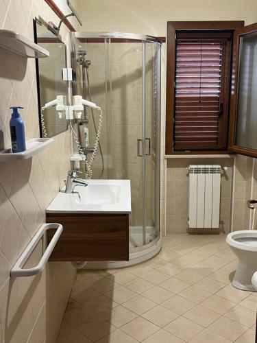 a bathroom with a shower and a sink and a toilet at Villa Bella Vista in Capo Vaticano
