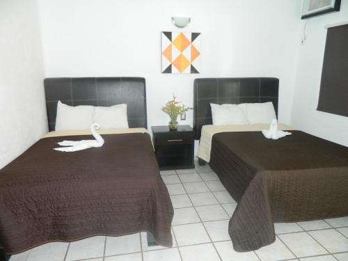 Un pat sau paturi într-o cameră la Splash Inn Nuevo Vallarta & Parque Acuatico