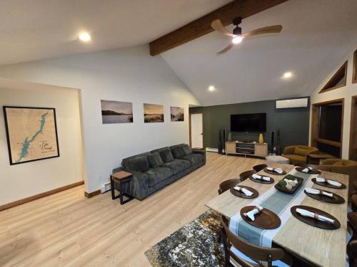a living room with a couch and a table at Pool Arcade Mtn Views Lake George Home Retreat WFH in Lake George
