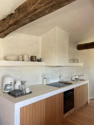 a kitchen with white cabinets and a counter top at Cerquido by NHôme in Cerquido