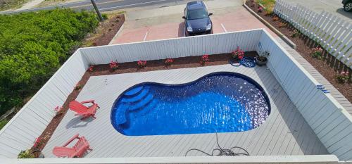 an overhead view of a swimming pool on a building at Beach Road Bed and Breakfast in Kill Devil Hills