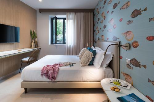 a bedroom with a bed and a desk and a tv at Belduomo in Taormina