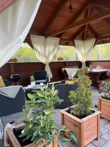 a patio with tables and chairs and potted plants at Willa Angel in Władysławowo