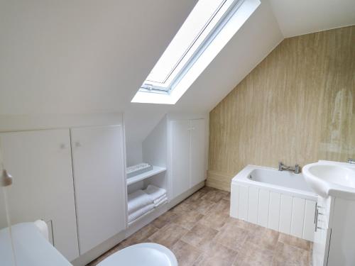 a bathroom with a sink and a skylight at 2 Penporth in Rhayader