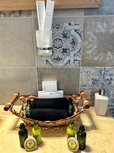 a basket filled with bottles on top of a kitchen counter at Golden moments Luxury Stone Villas A in Mesaria