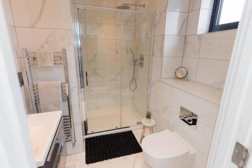 a bathroom with a shower and a toilet and a sink at The Broad Oaks in Olton