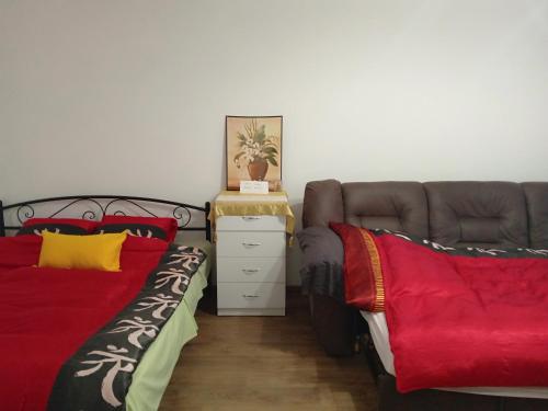 a bedroom with two beds and a couch at Апартамент в Новобудові Стрийська Автовокзал in Lviv