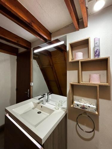 a bathroom with a sink and a mirror at Chalet de montagne in Ustou