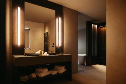 a bathroom with a sink and a mirror at Signature by Vík Apartments in Vík