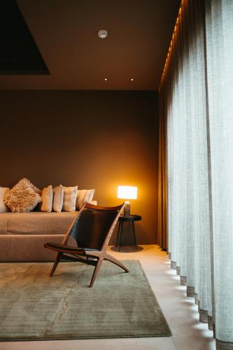 a living room with a couch and a chair at Signature by Vík Apartments in Vík
