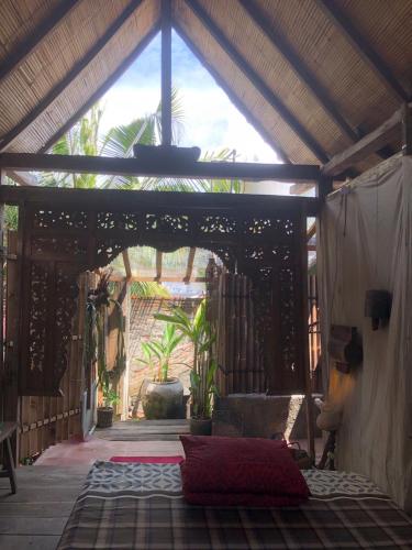 a room with a bed in a pavilion at Omah Guyub in Ngabean