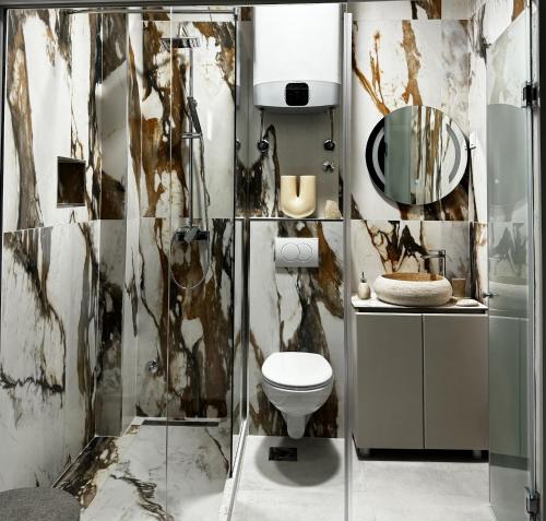a bathroom with a toilet and a shower at Marco Polo in Petrovac na Moru