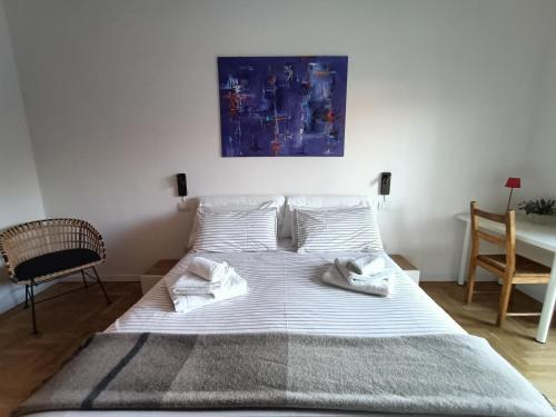 a bedroom with a bed with two towels on it at Blue Dream in Ispra
