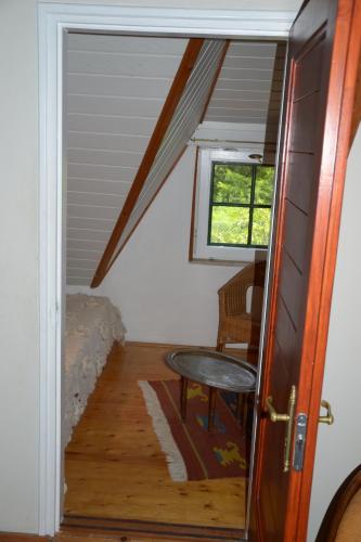 a door to a room with a table and a window at Gyöngy Villa in Fonyód