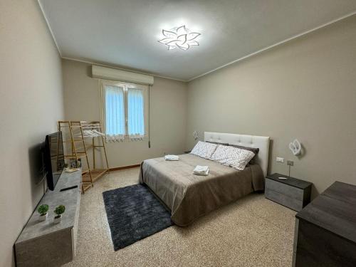 a bedroom with a bed and a television in it at Casa Ponte Romano in Faenza